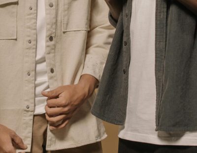 Stylish men's casual fashion featuring layered outfits with beige and gray tones.